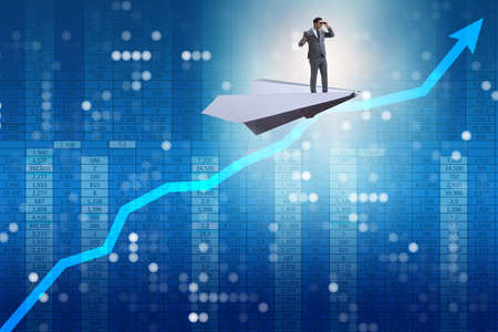 Businessman flying on paper plane in business conceptの写真素材