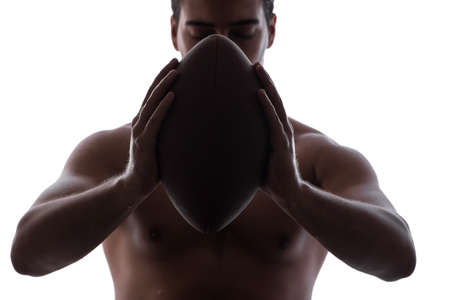 Ripped young man with american football isolated on white