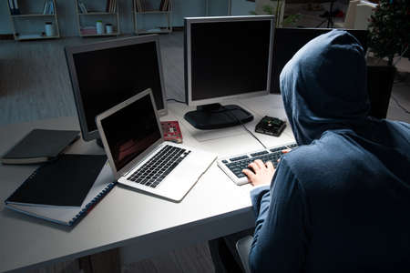 Hacker hacking computer at night