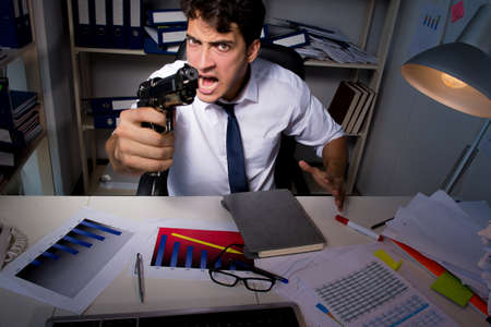 Man businessman working late hours in the officeの写真素材