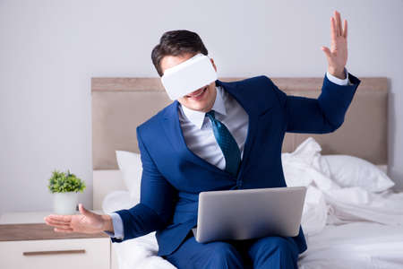 Businessman wearing a virtual reality headset in the bedroom