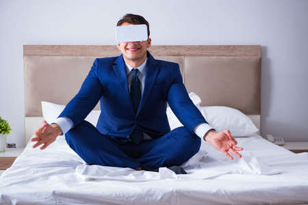 Businessman wearing a virtual reality headset in the bedroomの写真素材