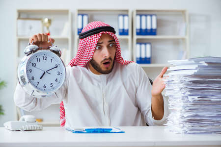 Arab businessman working in the office doing paperworkの写真素材