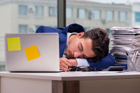 Workaholic businessman overworked with too much work in office