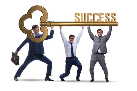 Businessmen holding giant key in business conceptの写真素材