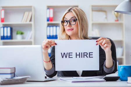 Young businesswoman with message in the officeの写真素材