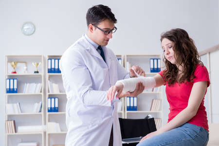 Doctor and patient during check-up for injury in hospitalの写真素材