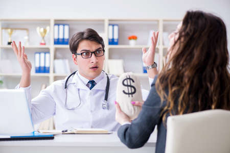 Young doctor in medical insurance fraud conceptの写真素材