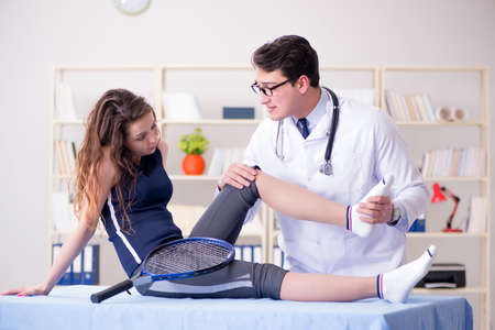 Man doctor taking care of sports injuryの写真素材