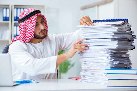Arab businessman working in the office doing paperwork with a piの写真素材