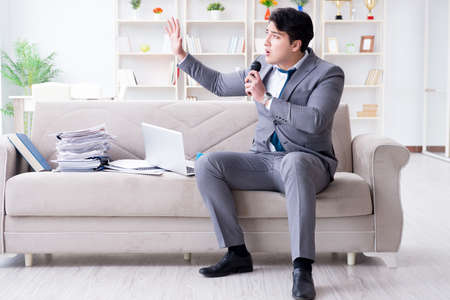 Sad businessman singing in officeの写真素材