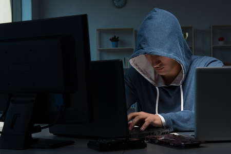Hacker hacking computer at nightの写真素材