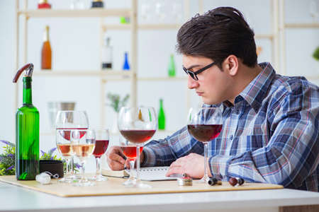 Professional sommelier tasting red wine