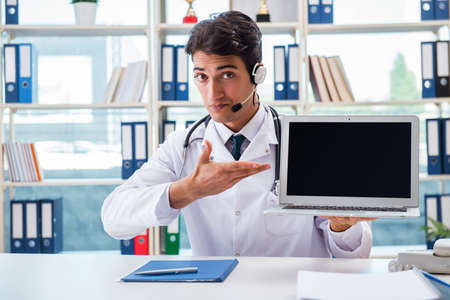 Young male doctor in telehealth conceptの写真素材