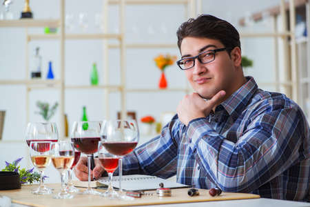 Professional sommelier tasting red wine