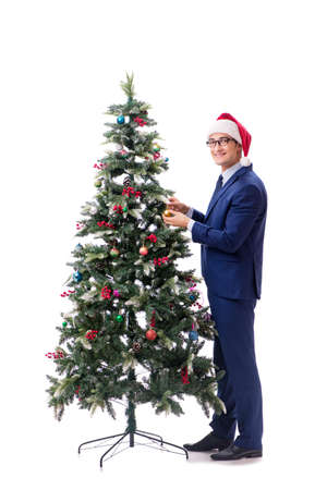 Businessman decorating christmas tree isolated on white backgroundの写真素材
