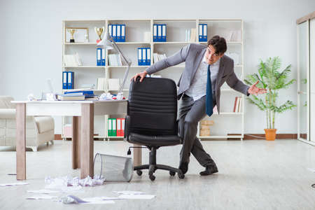 Businessman having fun taking a break in the office at workの写真素材