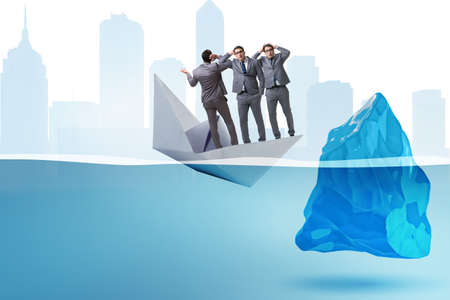 Economic crisis concept with businessman in sinking paper boatの写真素材