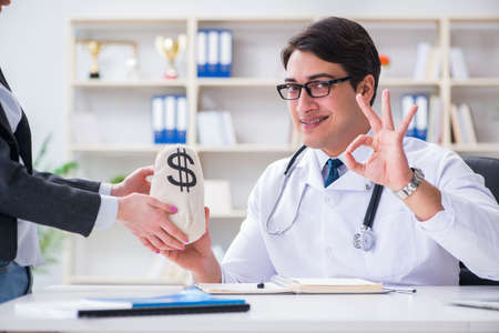 Young doctor in medical insurance fraud conceptの写真素材