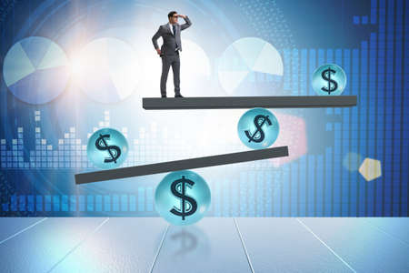 Businessman balancing in financial dollar conceptの写真素材
