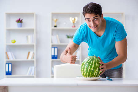 Man eating watermelon at homeの写真素材