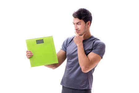 Man with scales in sports and health concept isolated on whiteの写真素材