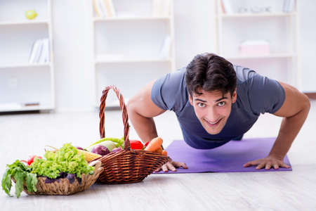 Man promoting the benefits of healthy eating and doing sportsの写真素材