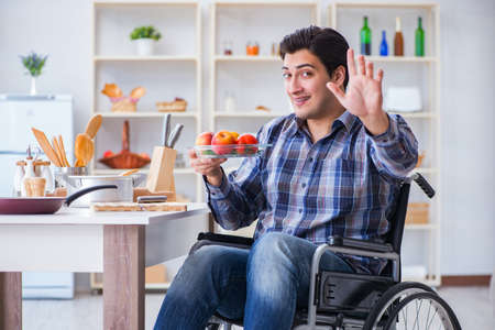 Young disabled husband preparing food saladの写真素材