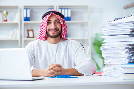 Arab businessman working in the office doing paperworkの写真素材