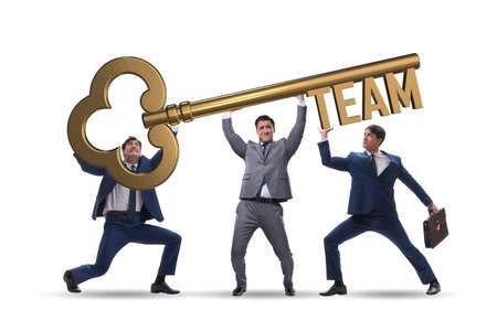 Businessmen holding giant key in team conceptの写真素材