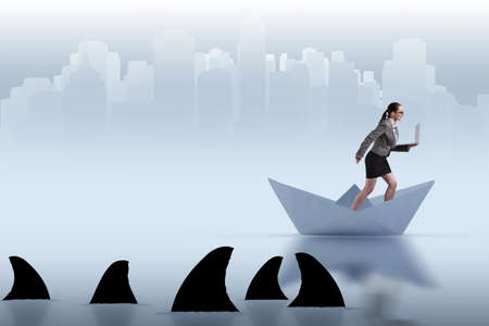 Businesswoman riding paper boat ship in business conceptの写真素材