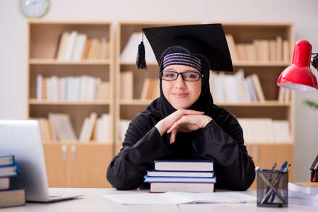Muslim girl in hijab studying preparing for examsの写真素材