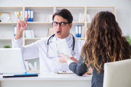 Young doctor in medical insurance fraud conceptの写真素材