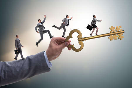 Business people chasing each other towards key to successの写真素材