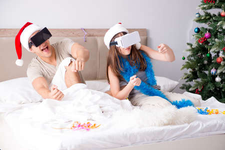 Happy couple celebrating christmas holiday in bed