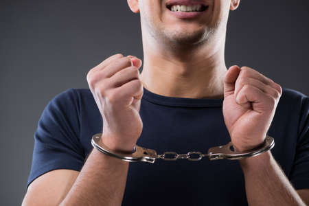 Man with his hands handcuffed in criminal conceptの写真素材