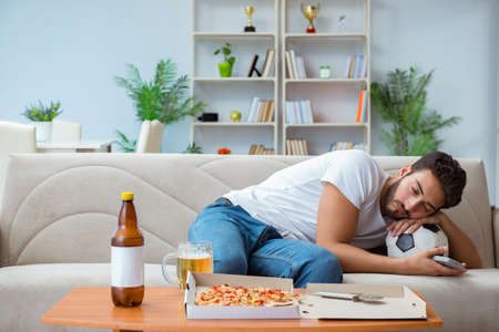 Man eating pizza having a takeaway at home relaxing restingの写真素材