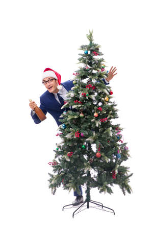Businessman decorating christmas tree isolated on whiteの写真素材