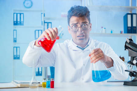 Funny mad chemist working in a laboratory