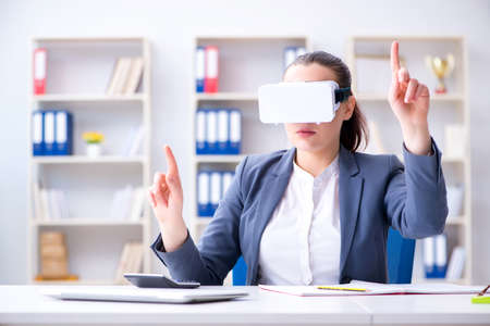 Businesswoman with virtual reality glasses in office