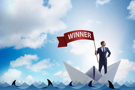 Businessman riding paper boat ship in winning conceptの写真素材