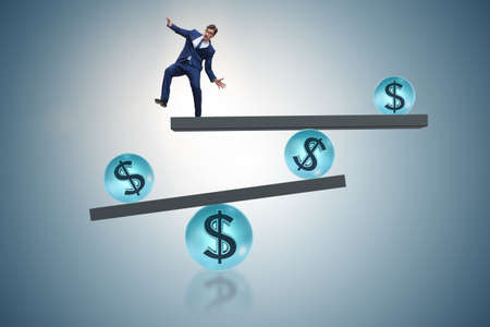Businessman balancing in financial dollar conceptの写真素材