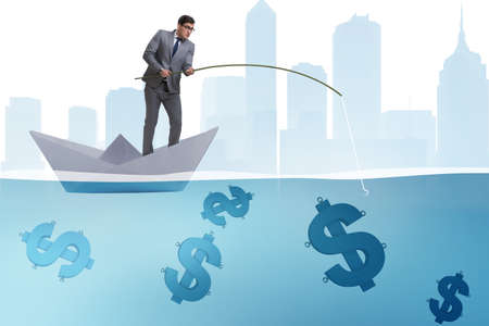 Businessman fishing dollars money from paper boat shipの写真素材
