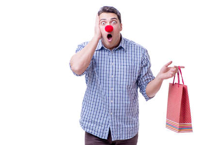 Man with a red nose funny holding a shopping bag gift present isの写真素材