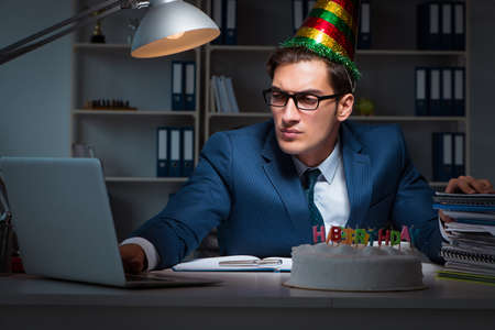 Man celebrating birthday in the officeの写真素材