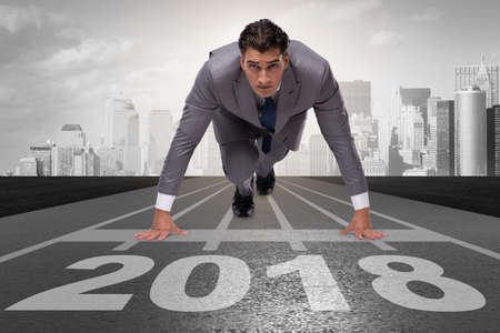 Businessman running towards new year 2018