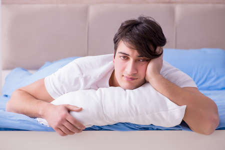 Man suffering from insomnia lying in bedの写真素材