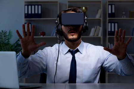 Businessman gamer staying late to play games