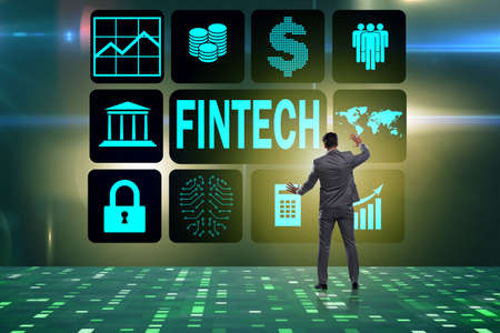 Businessman pressing buttons in fintech conceptの写真素材