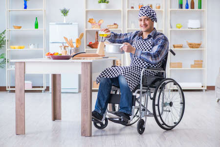 Disabled man preparing soup at kitchenの写真素材